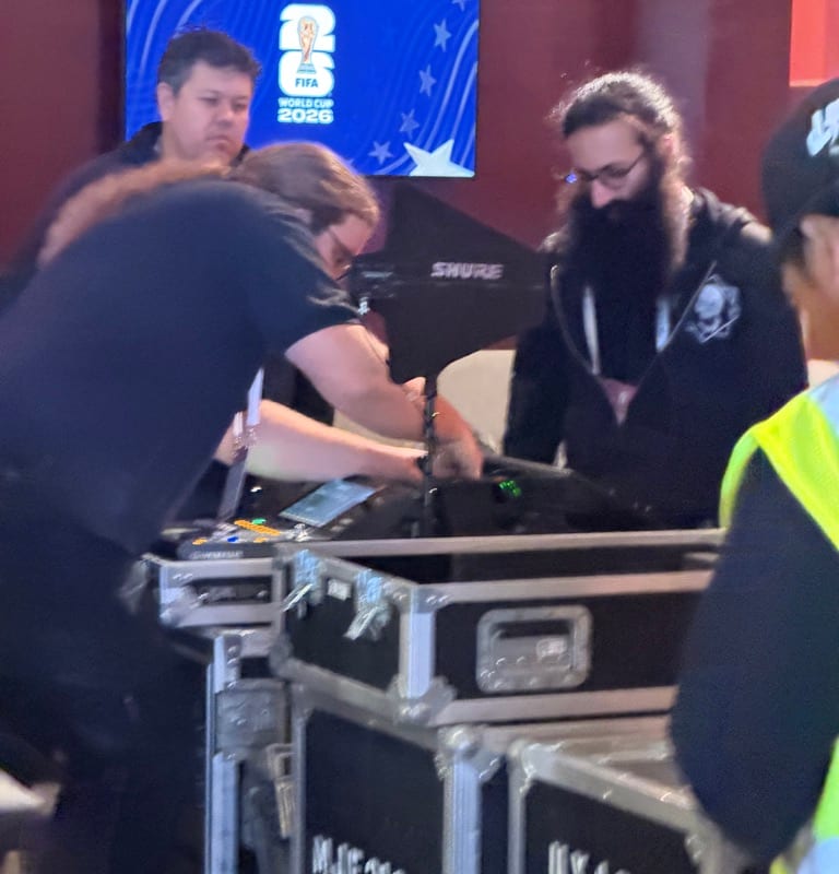 A road case stenciled 'KEITH URBAN — WCM-167 — FOH' on a wooden stage floor next to a Sound Image / Clair Global flight case.